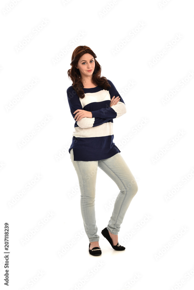 full length portrait of girl wearing striped blue and white jumper and jeans. standing pose on white studio background full length portrait of girl wearing striped blue and white jumper and jeans. standing pose on white studio background