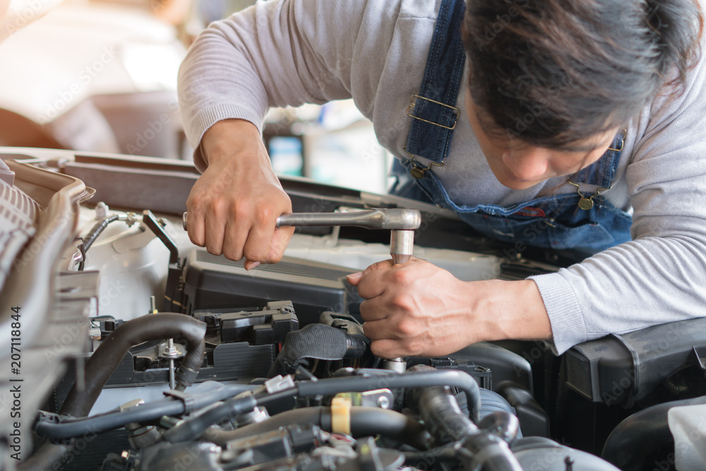 Hands of car mechanic in auto repair service. Hands of car mechanic in auto repair service.