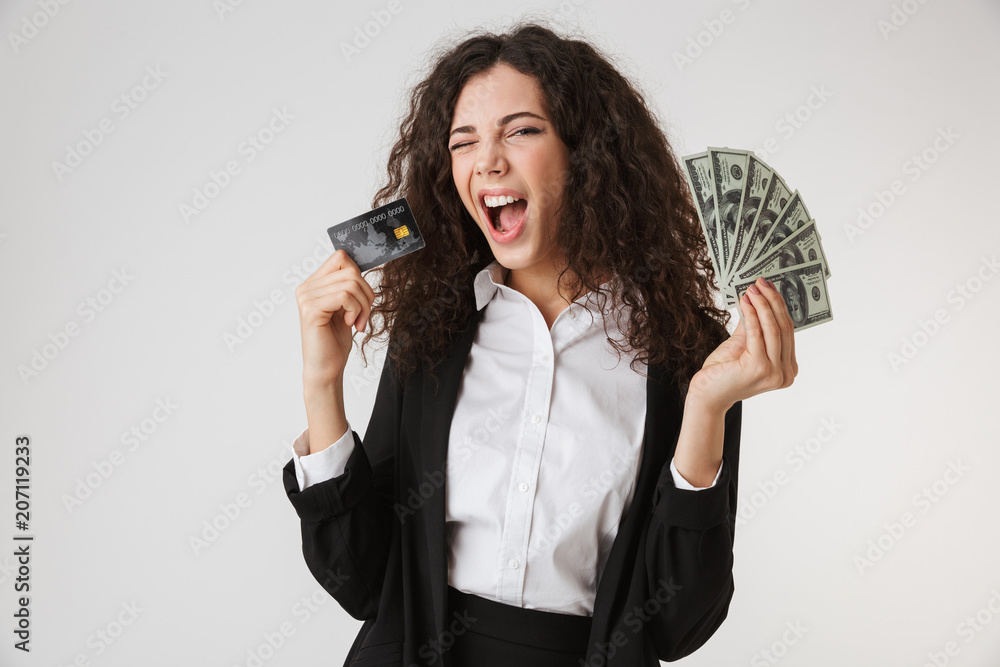 Excited happy young business woman with credit card and money. Excited happy young business woman with credit card and money.