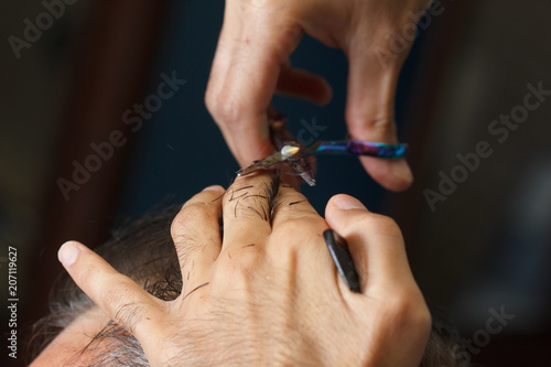 Male client getting haircut by hairdresser. barbershop