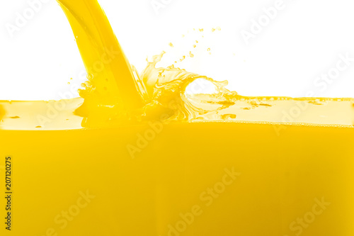 orange juice splashing against white background
