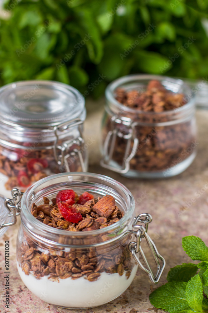 Chocolate granola in the jar, healthy breakfast