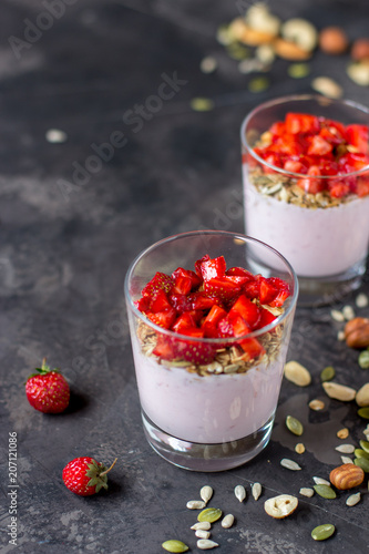 Granola with yogurt, strawberry and nuts, healthy breakfast