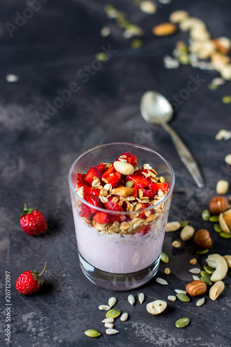 Granola with yogurt, strawberry and nuts, healthy breakfast
