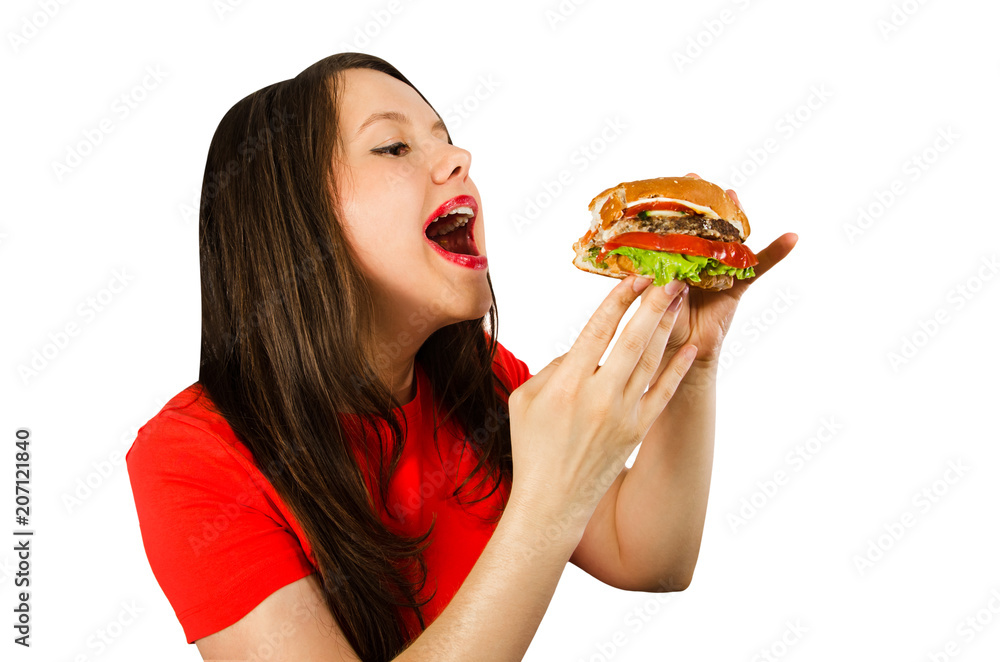 Young woman holds burger with opened mouth and want eats him, isolated on white background. Young woman holds burger with opened mouth and want eats him, isolated on white background.