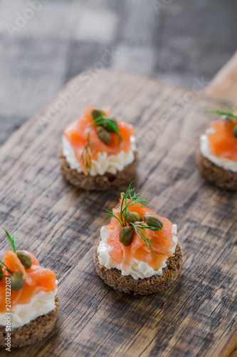 Mini catering sandwiches with cream cheese, smoked salmon, capers and dill.