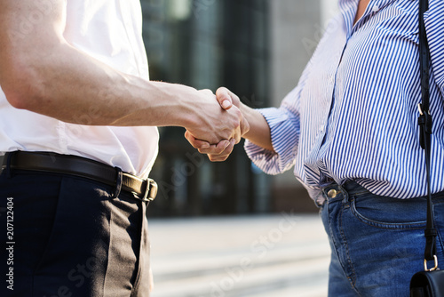 People greeting by shaking hands