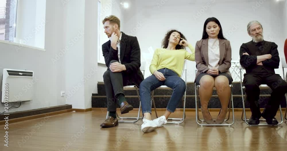 Addicted people with coach sittin on chairs in a row after froup meeting. Support concept. Addicted people with coach sittin on chairs in a row after froup meeting. Support concept.