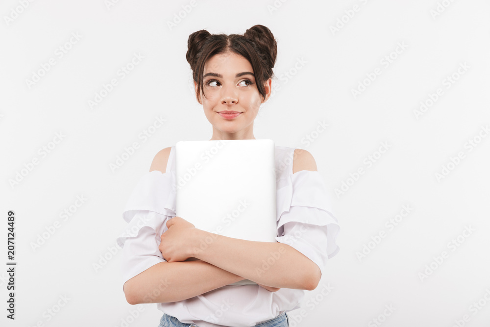 Photo of adorable teenagewoman with double buns hairstyle smiling and hugging silver laptop, isolated over white background Photo of adorable teenagewoman with double buns hairstyle smiling and hugging silver laptop, isolated over white background