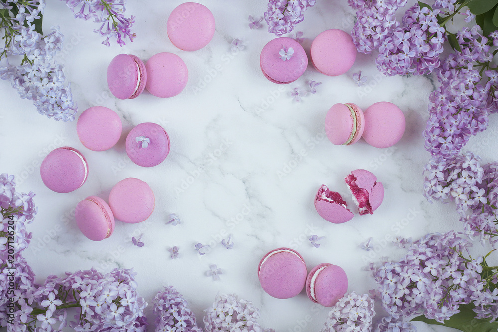 Macaroons on a marble background with lilac flowers, Light background, Confectionery in a blogger style Macaroons on a marble background with lilac flowers, Light background, Confectionery in a blogger style