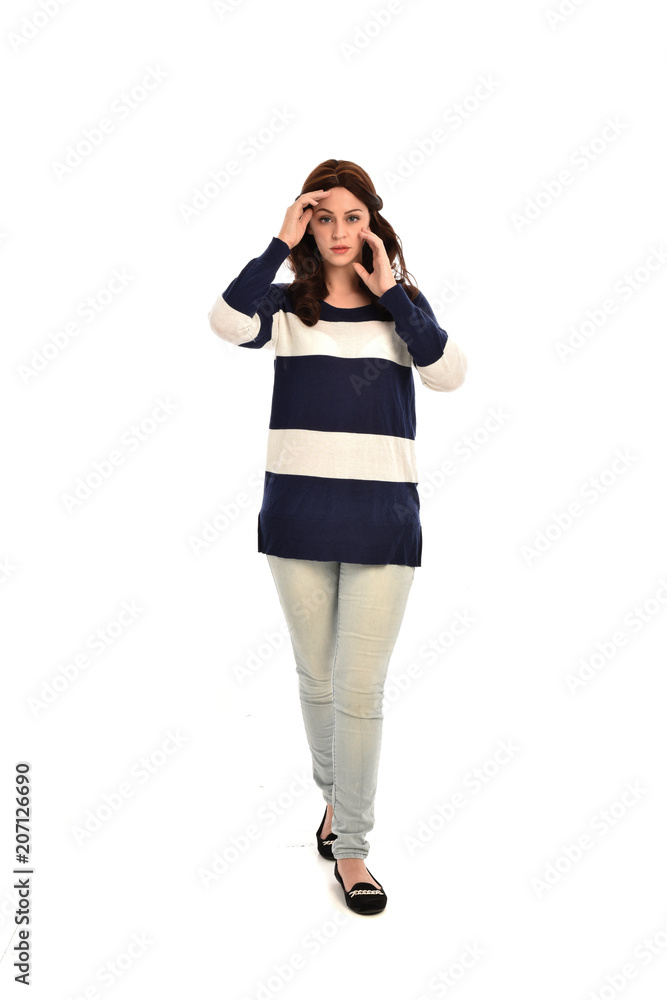 full length portrait of girl wearing striped blue and white jumper and jeans. standing pose on white studio background full length portrait of girl wearing striped blue and white jumper and jeans. standing pose on white studio background