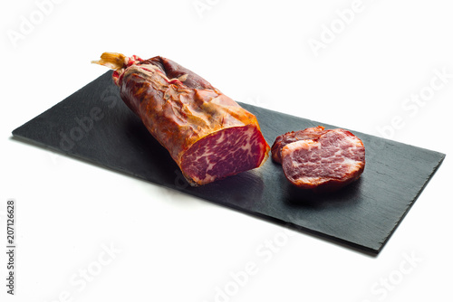 black tray of delicious Iberian pork loin on white background photo