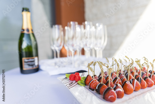 Champagne and chocolate covered strawberries served as an appetizer snack and welcome drink at an event party