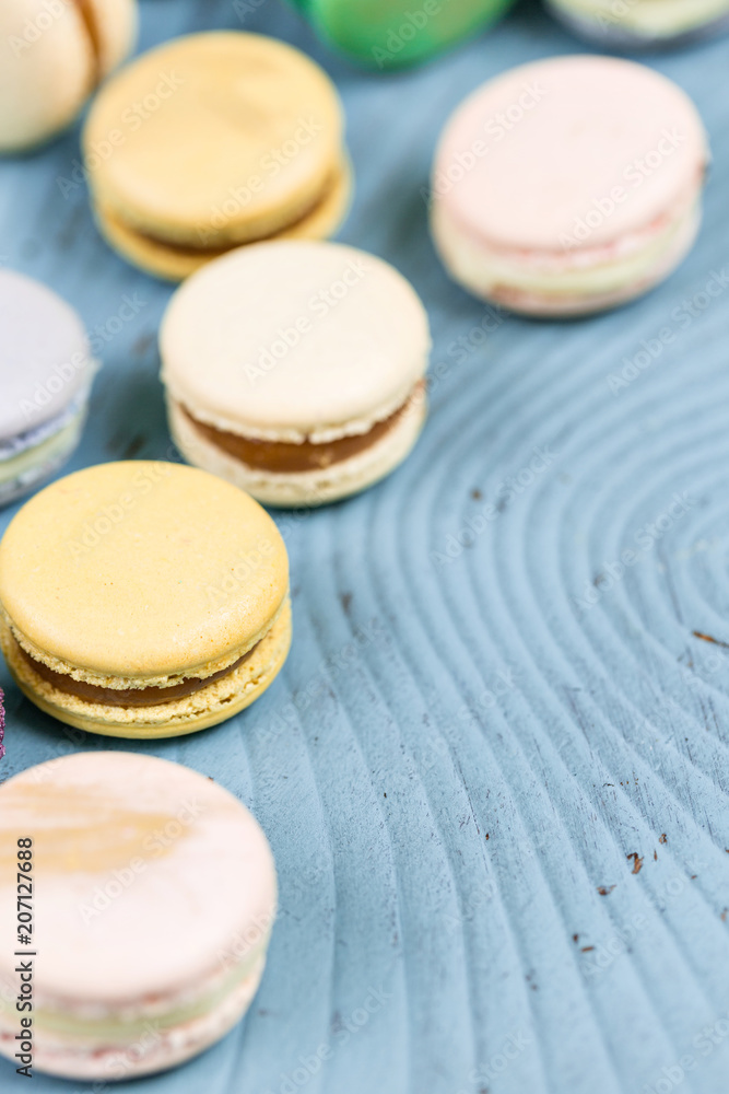 French macaroon dessert and flowers eucalyptus on a turquoise background. pastel colors French macaroon dessert and flowers eucalyptus on a turquoise background. pastel colors