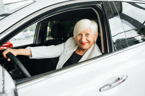 Aged woman buy car. © Мария Кокулина