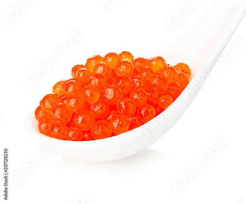 Porcelain spoon with red caviar isolated on white background.