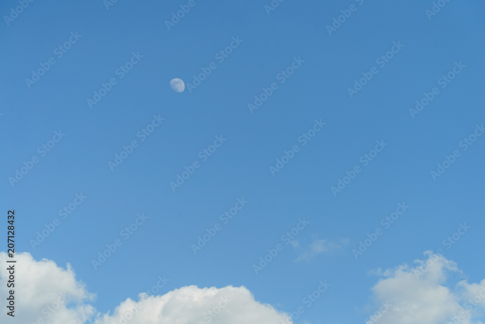 Moon during the day, blue sky with clouds Moon during the day, blue sky with clouds