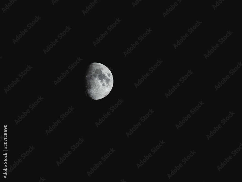 Natural night background with dark sky and half Moon, Earth satellite. Waxing gibbous phase. Natural night background with dark sky and half Moon, Earth satellite. Waxing gibbous phase.