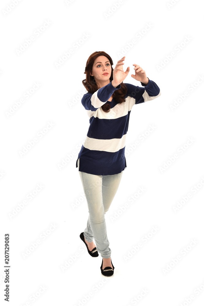full length portrait of girl wearing striped blue and white jumper and jeans. standing pose on white studio background full length portrait of girl wearing striped blue and white jumper and jeans. standing pose on white studio background