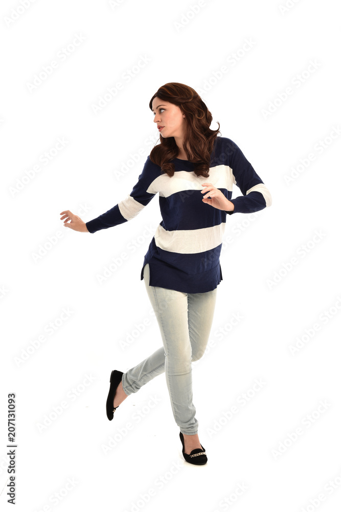 full length portrait of girl wearing striped blue and white jumper and jeans. standing pose on white studio background full length portrait of girl wearing striped blue and white jumper and jeans. standing pose on white studio background