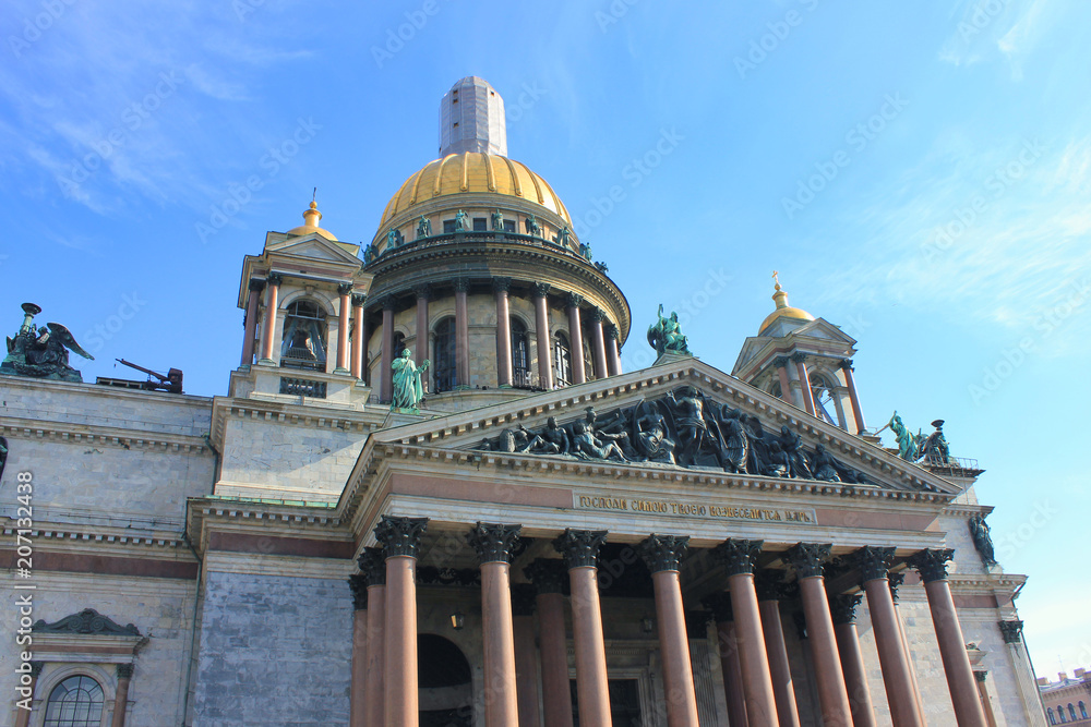 St. Isaac's Cathedral Orthodox Basilica and Museum Building in Saint-Petersburg, Russia. Famous Russian Neoclassical Style Architecture, Cultural Travel Landmark View on Sunny Day against Blue Sky.