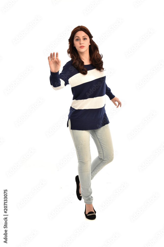 full length portrait of girl wearing striped blue and white jumper and jeans. standing pose on white studio background full length portrait of girl wearing striped blue and white jumper and jeans. standing pose on white studio background