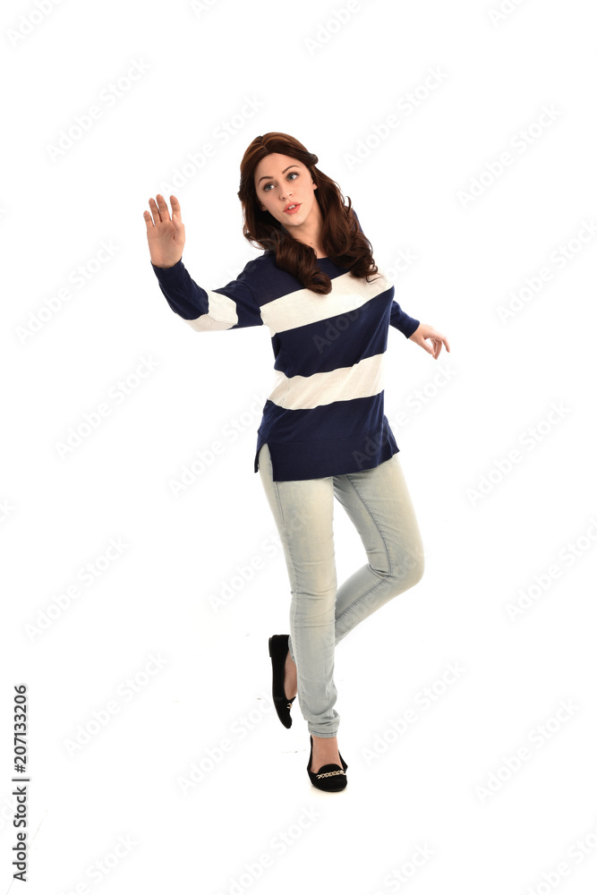 full length portrait of girl wearing striped blue and white jumper and jeans. standing pose on white studio background full length portrait of girl wearing striped blue and white jumper and jeans. standing pose on white studio background