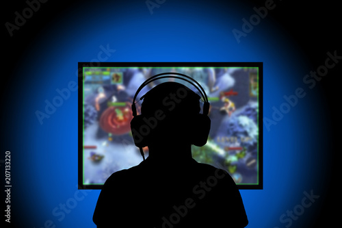 Silhouette,Young man playing video games on pc at home