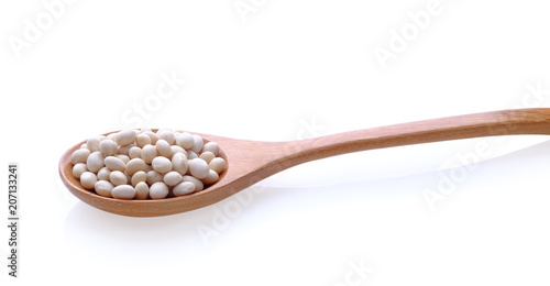 white beans in wood spoon on white background