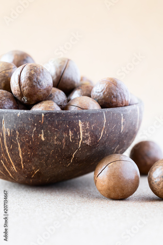 Whole Macadamia nuts in coconut bowl