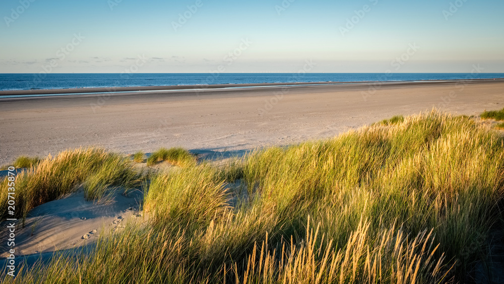 The colortones are becoming warmer when the evening has arrived on the shore of the Wadden Island of Schiermonnikoog (Friesland, the Netherlands) on a sunny late September afternoon.