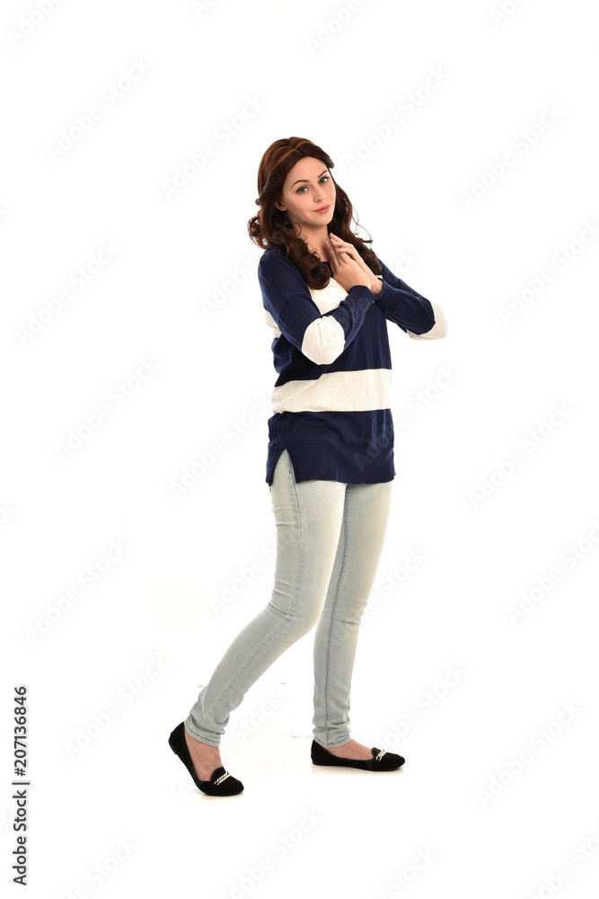 full length portrait of girl wearing striped blue and white jumper and jeans. standing pose on white studio background full length portrait of girl wearing striped blue and white jumper and jeans. standing pose on white studio background