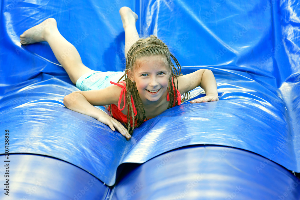 Delighted girl on inflatable attraction