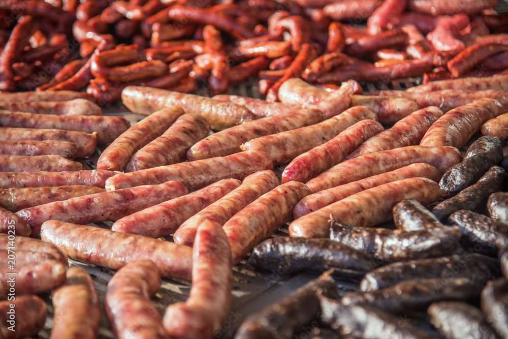 Different kinds of fresh spanish sausages hanging in bunches on the marketplace. Soft focus.3 Different kinds of fresh spanish sausages hanging in bunches on the marketplace. Soft focus.3
