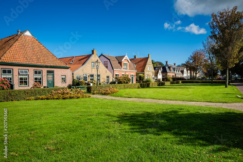 Old and gorgeous houses are scattered along the main street of the village of Schiermonnikoog on the Dutch Wadden Isle of the same name. Photo is shot in September.