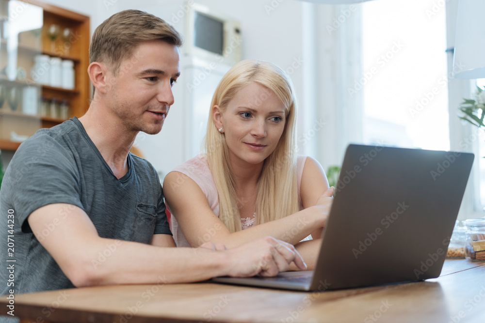 Couple browsing the internet together on a laptop Couple browsing the internet together on a laptop