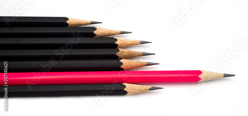 many group of black pencils but pink color is standing out from crowd