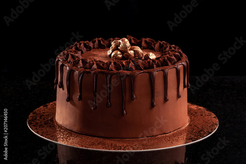Chocolate cake with nuts on a black background