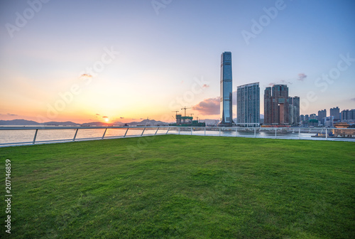 Canvas Print green lawn with city skyline in hongkong china