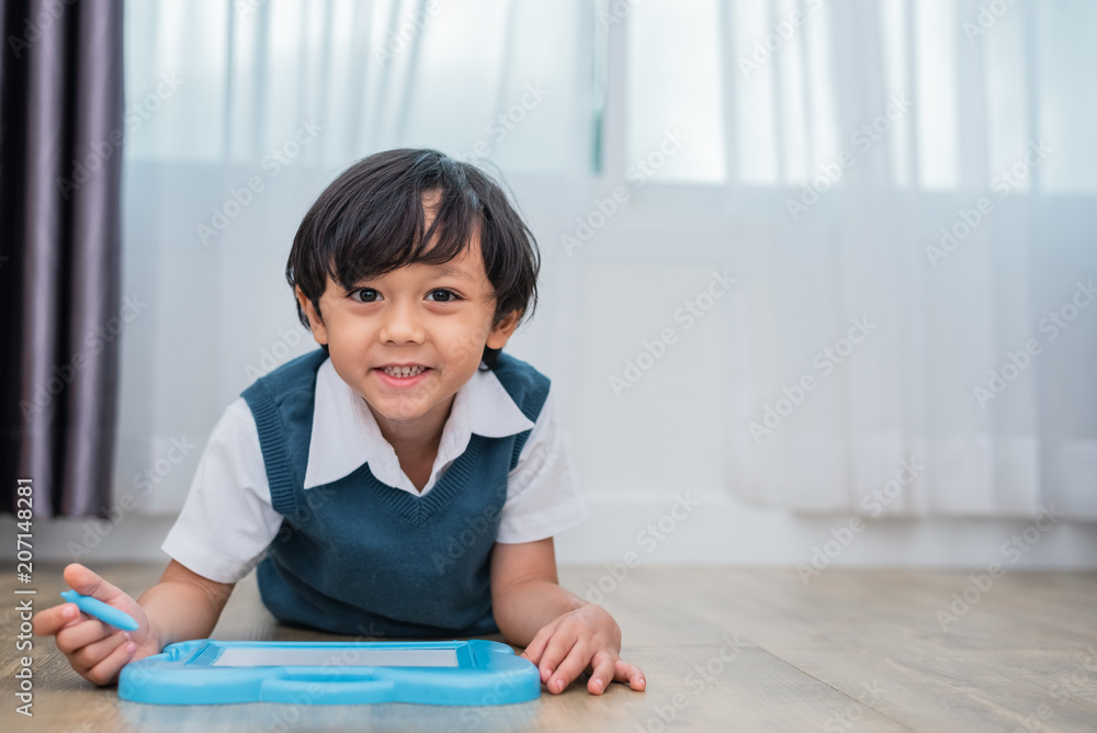 Little boy drawing cartoon in chalkboard in home. Education and Back to school concept. Kids development theme. Little boy drawing cartoon in chalkboard in home. Education and Back to school concept. Kids development theme.