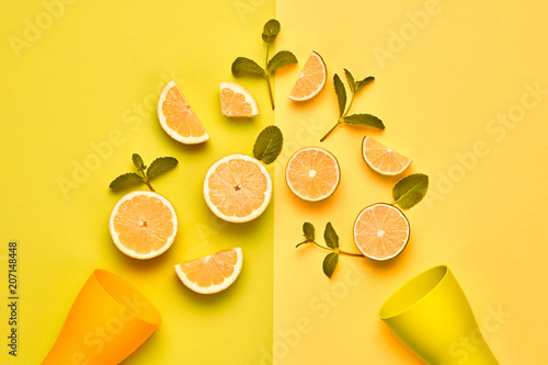 Citrus Fresh Fruit with Mint leaves. Vegan juice Organic Food Concept. Creative Yellow Layout. Flat lay. Trendy Summer fashion Style. Minimal Design Art. Bright Color.