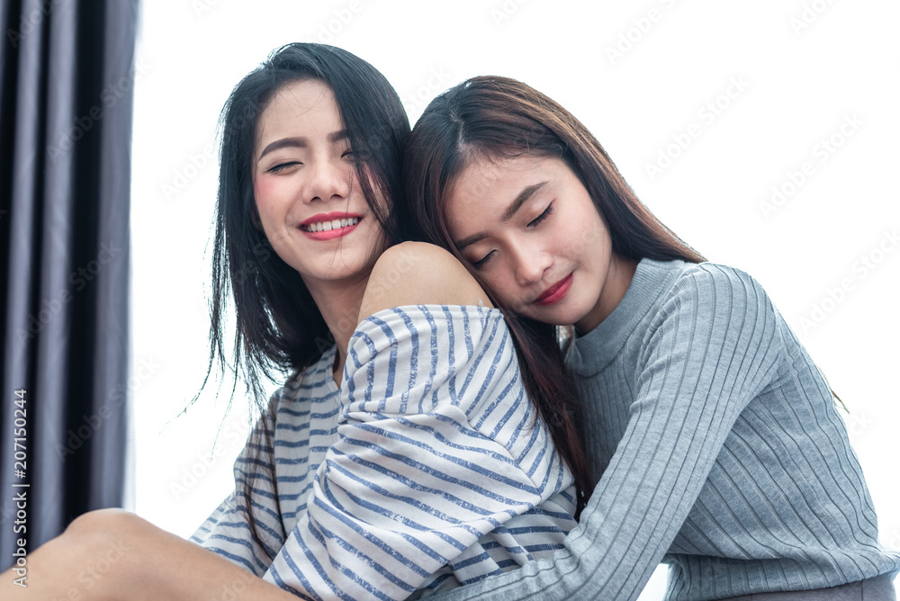 Two Asian Lesbian women hug and embracing together in bedroom. Couple people and Beauty concept. Happy lifestyles and home sweet home theme. Homosexual life theme. Love scene making of female Two Asian Lesbian women hug and embracing together in bedroom. Couple people and Beauty concept. Happy lifestyles and home sweet home theme. Homosexual life theme. Love scene making of female