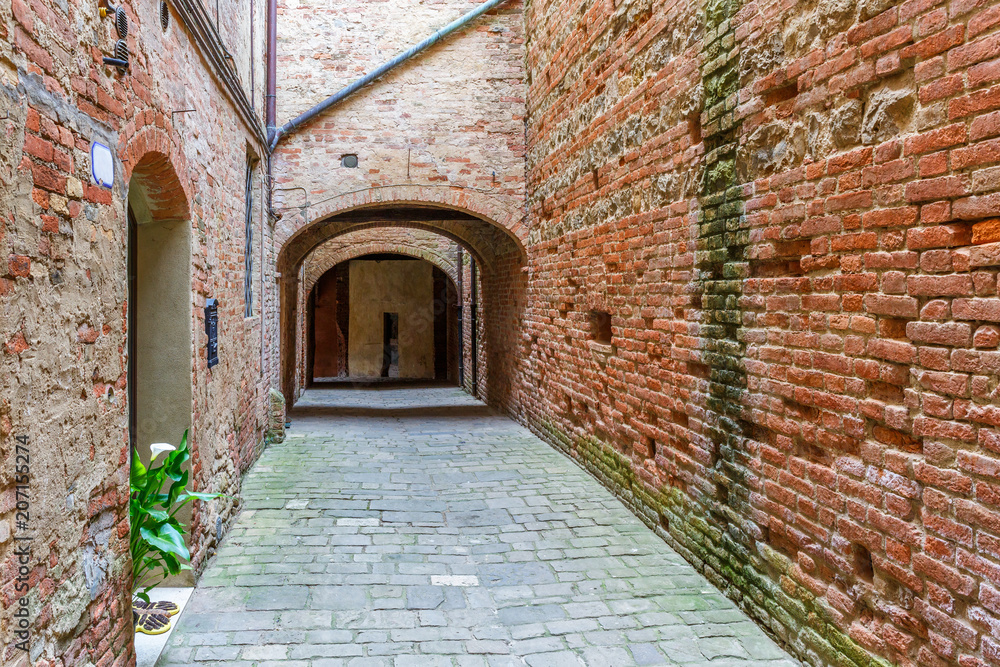 Alley with brick walls in an Italian village