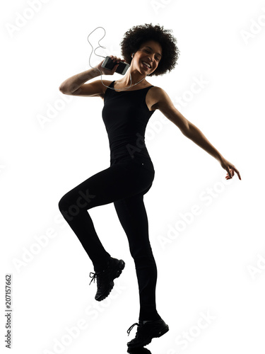 one mixed race african young teenager girl woman happy dancer dancing listening music in studio shadow silhouette isolated on white background