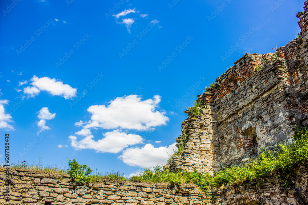 frame of old stone wall with blue sky background and empty space for copy or text