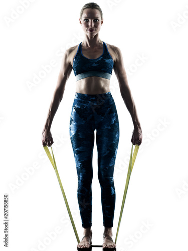 one caucasian woman exercising fitness elastic excercises in silhouette isolated on white background