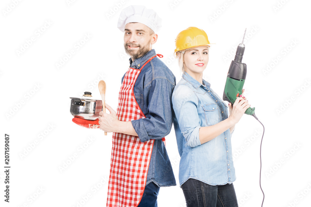 Portrait of male cook with saucepan and pretty woman in helmet with drill smiling at camera on white background Portrait of male cook with saucepan and pretty woman in helmet with drill smiling at camera on white background