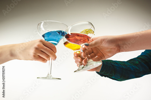 The male and female hands with exotic cocktails