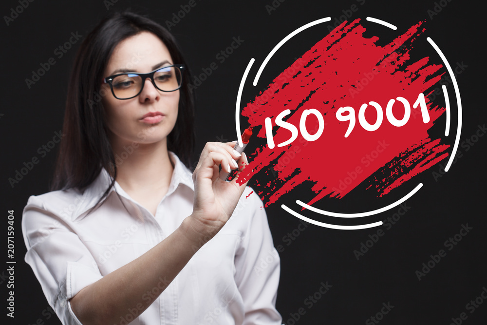 The concept of marketing, technology, the Internet and the network. A young businessman shows what is important for business: ISO 9001 The concept of marketing, technology, the Internet and the network. A young businessman shows what is important for business: ISO 9001