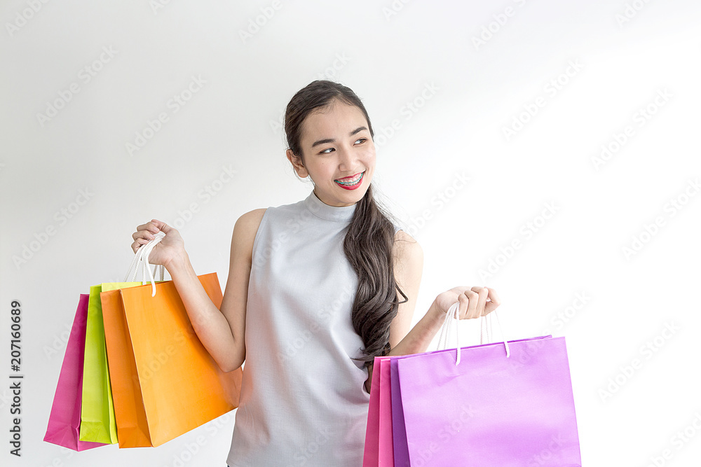 Beautiful asian girl carrying shopping bags. Shopping woman smiling. Beautiful Asian girl. young shopper.
